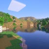 A screenshot of a river in Minecraft, with some trees on either side of the bank and a hill in the distance, taken using Vanilla Plus shaders.