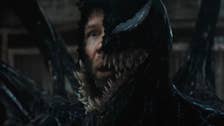 A still from Venom: The Last Dance of Tom Hardy as Eddie Brock, half of his face visible underneath Venom.