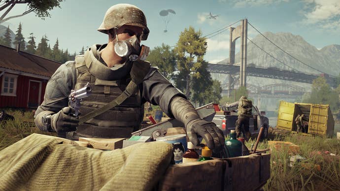 An Outlander in gasmask and helmet, holding a pistol, protects a crate of supplies including cat food in survival looter-shooter Vigor