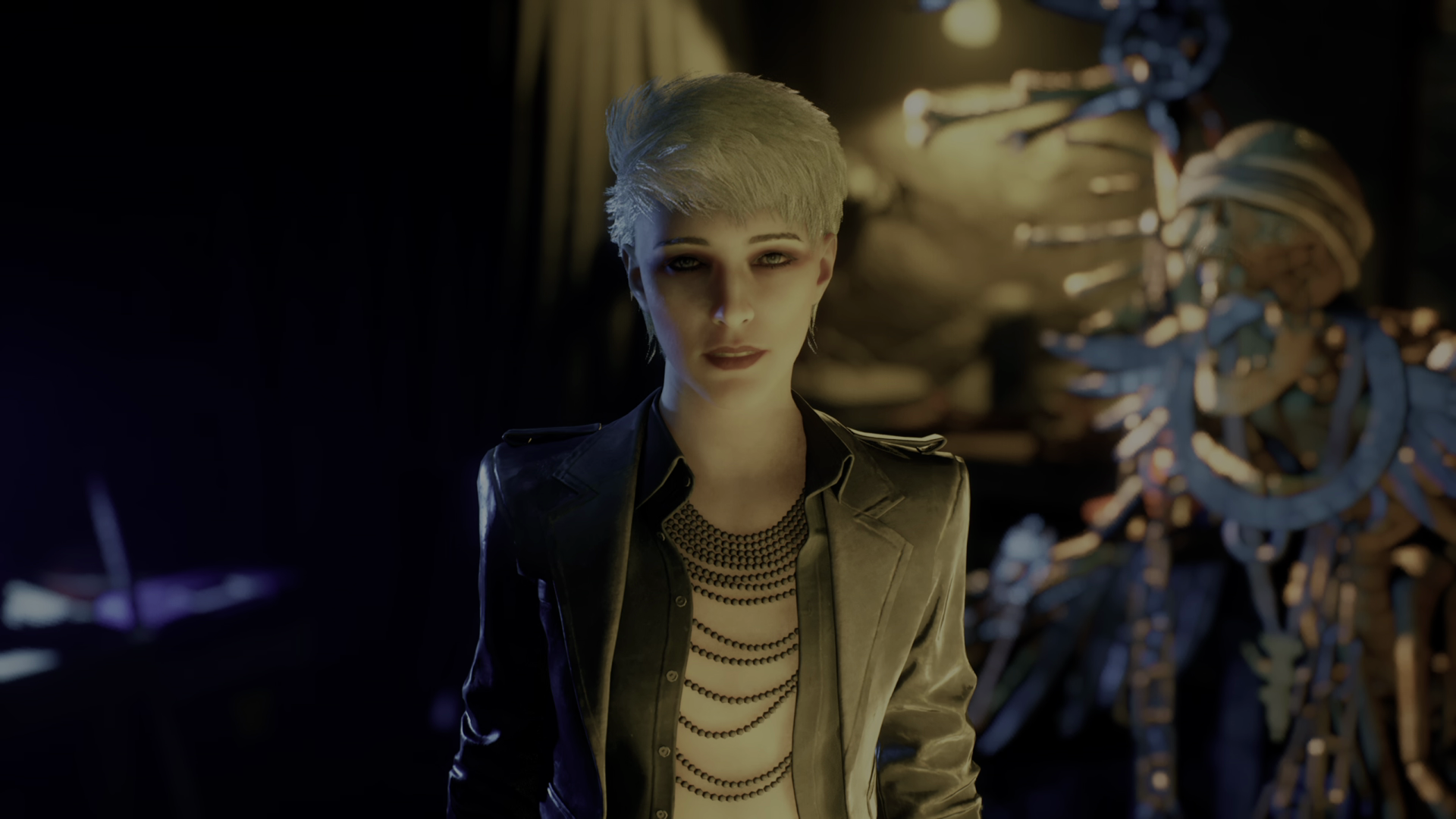 Patience — a young-looking vampire with short white-blonde hair, wearing a leather jacket over several strings of bead necklaces and either a flesh-coloured shirt or none at all — looks at the player in Vampire: The Masquerade Bloodlines 2. - 10