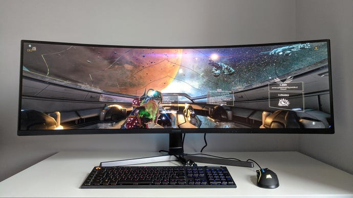 A photo of an ultrawide gaming monitor running Warframe