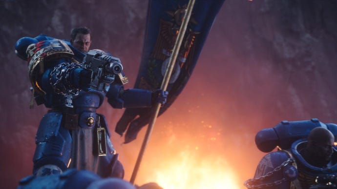 Titus points a bolt gun while bearing the standard of his battalion.