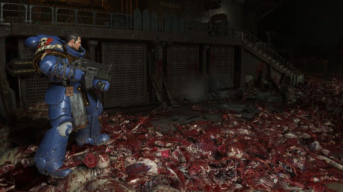 Titus stands on top of a pile of alien gore.