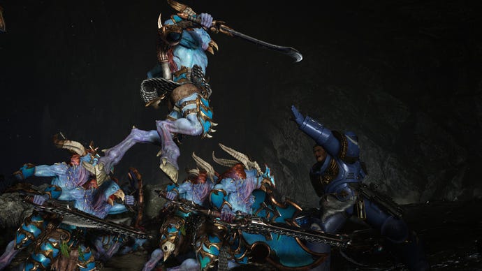 Titus raises his arm to catch a chaos enemy as it leaps on him.