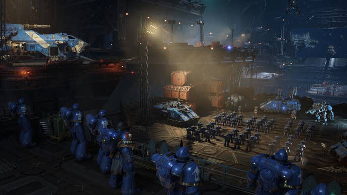 Units of space marines muster on the flight deck of a space ship.