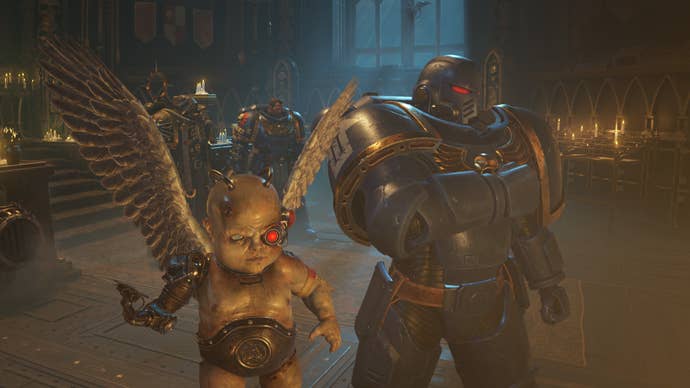 A cherub with cybernetic implants flies on the spot next to a space marine.