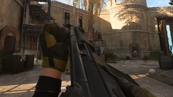 The player in Warzone 2.0 inspects their weapon, the Lachmann-556.