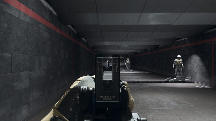 The player in Warzone 2.0 aims at a training dummy using the Cronen Irons optic attachment.