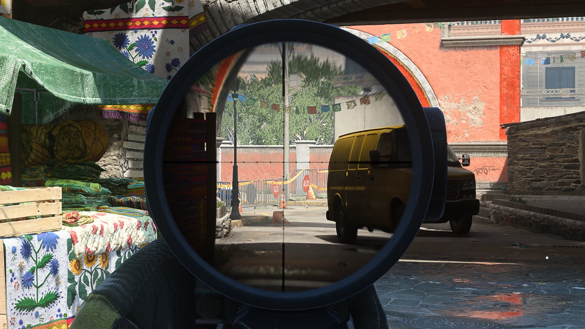 A sniper in Warzone 2.0 aims down their sniper scope to cover a long sightline down a road.