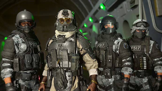 A squad of four soldiers stand side by side and look at the camera from the bay of an aircraft in Warzone 2.0.