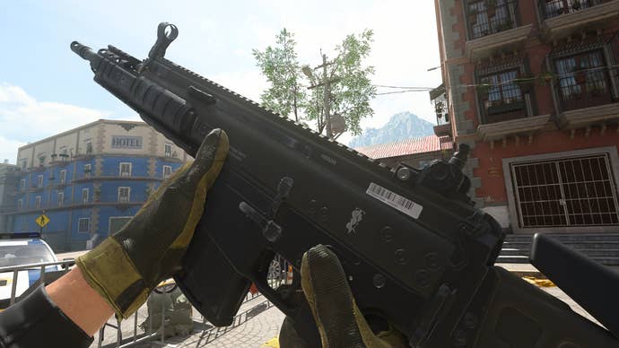 The player in Warzone 2.0 inspects their weapon, the TAQ-M.