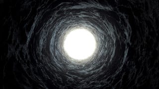 A photograph from the bottom of a well looking up towards the light. It's all darkness apart from the top of the well and some semblance of bricks on it.