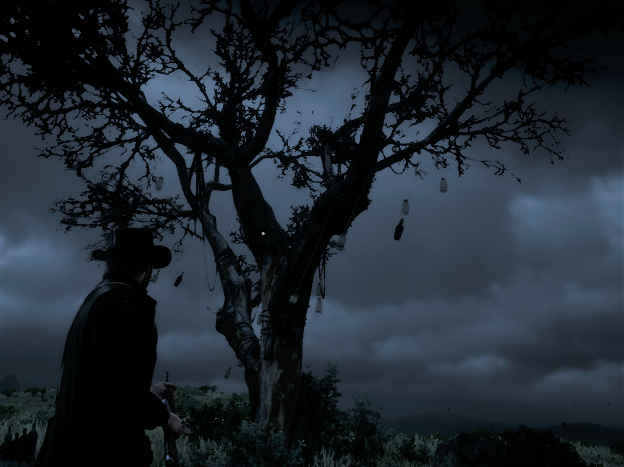 Arthur Morgan standing by the Whisky Tree at night in Red Dead Redemption 2. - 1