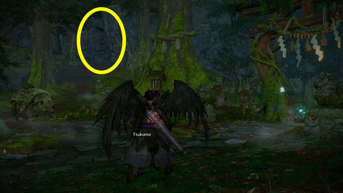 The player in Wild Hearts stands outside the starting campsite. A wall of rock that can be blown apart to reveal a shortcut has been highlighted.