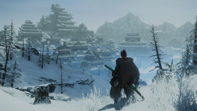 Wild Hearts review - the player character looks out over snow-covered scenery and a pyramid of buildings