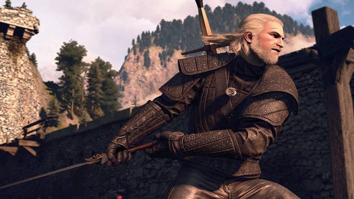 The Witcher 3 saddlebags: A man with black armor and white hair stands in front of a stone house in an action pose. He’s holding a sword behind him, preparing to swing