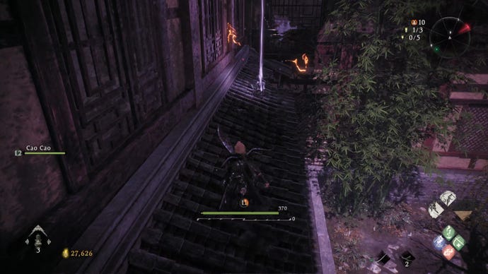 A Wo Long: Fallen Dynasty screenshot of the player standing next to a flag.