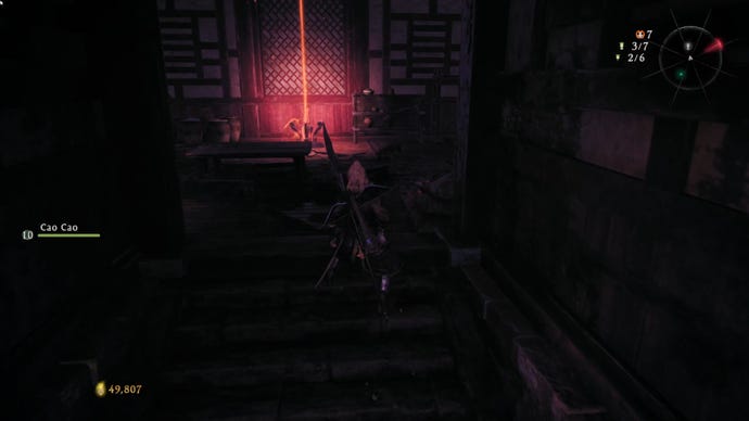 A Wo Long: Fallen Dynasty screenshot of the player standing next to a flag.