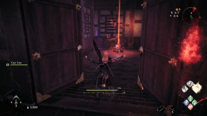 A Wo Long: Fallen Dynasty screenshot of the player standing next to a flag.