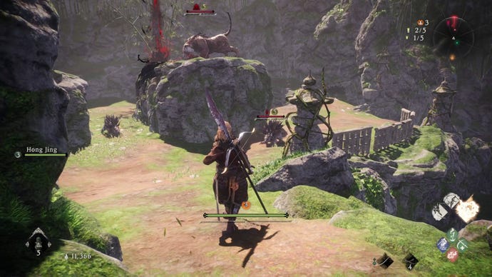 A Wo Long: Fallen Dynasty screenshot of the player standing next to a flag.