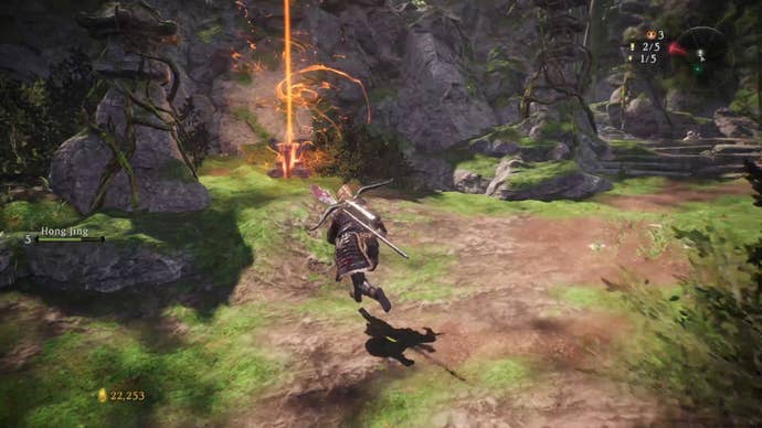 A Wo Long: Fallen Dynasty screenshot of the player standing next to a flag.