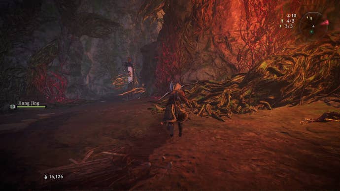 A Wo Long: Fallen Dynasty screenshot of the player standing next to a flag.