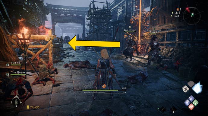 The player in Wo Long stands in front of a Battle Flag on a road, with an arrow indicating the location of the nearest Shitieshou.