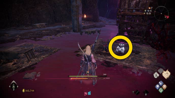 The player in Wo Long meets a Shitieshou in the middle of a red watery area.