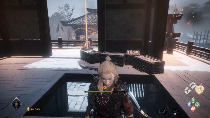 A Wo Long: Fallen Dynasty screenshot of the player standing next to a flag.