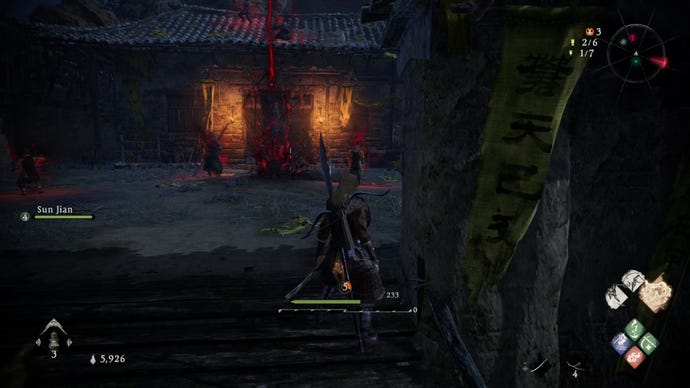 A Wo Long: Fallen Dynasty screenshot of the player standing next to a flag.