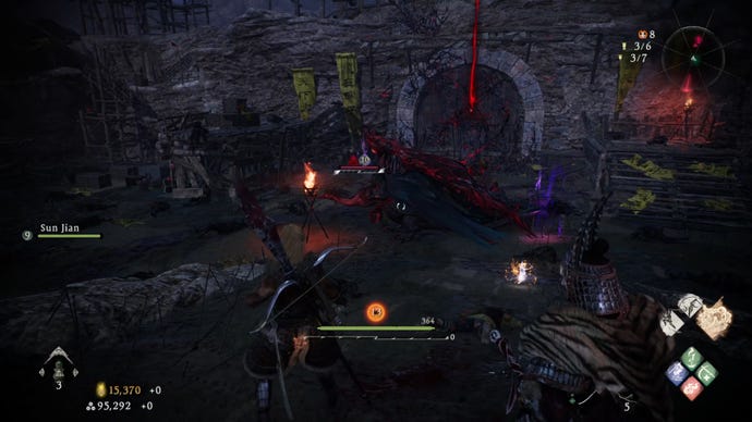 A Wo Long: Fallen Dynasty screenshot of the player standing next to a flag.