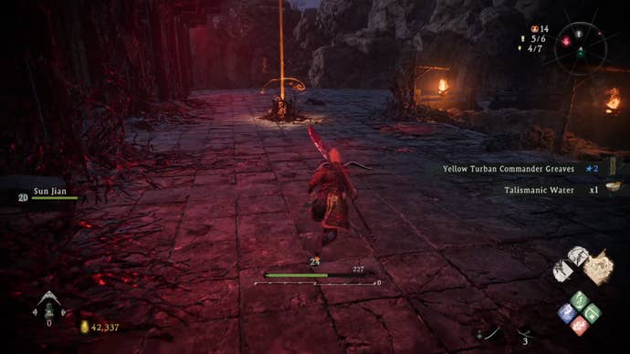 A Wo Long: Fallen Dynasty screenshot of the player standing next to a flag.