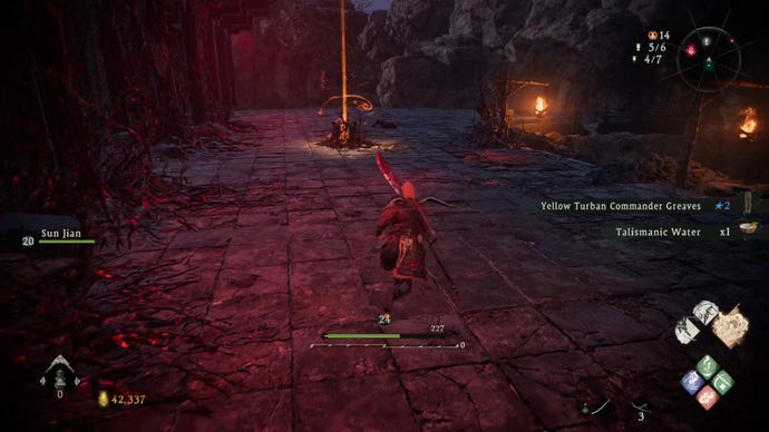 A Wo Long: Fallen Dynasty screenshot of the player standing next to a flag.