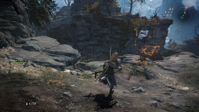 A Wo Long: Fallen Dynasty screenshot of the player standing next to a flag.