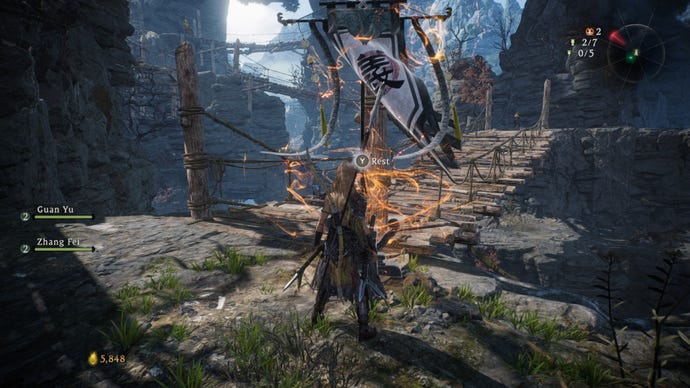 A Wo Long: Fallen Dynasty screenshot of the player standing next to a flag.