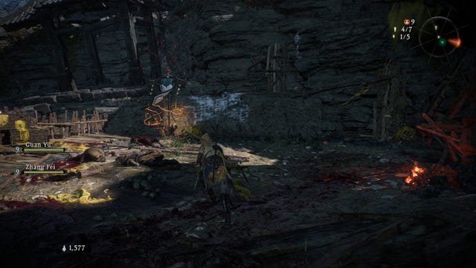 A Wo Long: Fallen Dynasty screenshot of the player standing next to a flag.