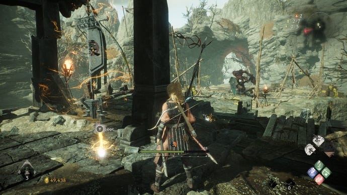 A Wo Long: Fallen Dynasty screenshot of the player standing next to a flag.