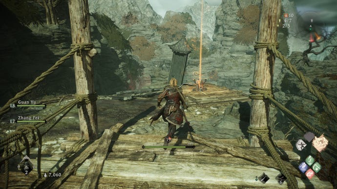 A Wo Long: Fallen Dynasty screenshot of the player standing next to a flag.