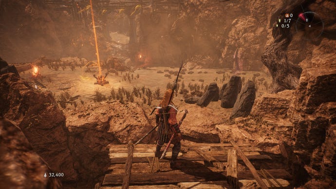 A Wo Long: Fallen Dynasty screenshot of the player standing next to a flag.