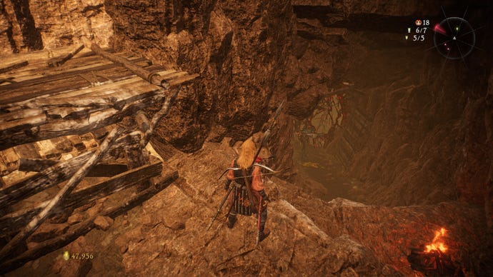 A Wo Long: Fallen Dynasty screenshot of the player standing next to a flag.