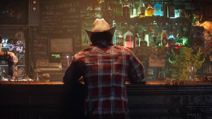 The back of Wolverine from the announcement teaser for Insomniac’s upcoming Wolverine game. He is sitting at a bar and wearing a red plaid shirt and cowboy hat.