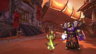 An Orc shaman stands next to a glowing green totem in the centre of Orgrimmar in World Of Warcraft: Classic.