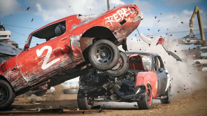 A red and black car slams into the side of another red racecar and sends it into the air, showering splinters of metal and plastic everywhere.