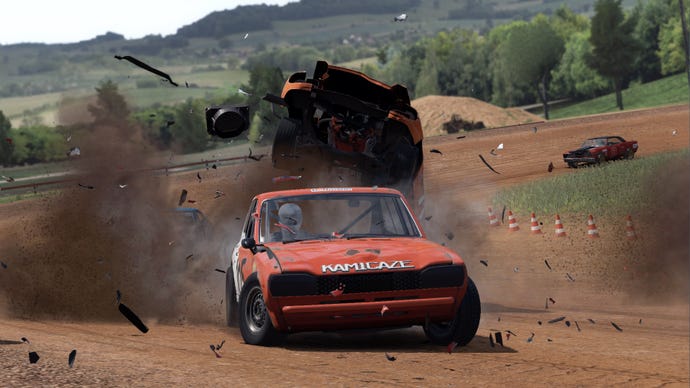 A red car drives away from a crash behind it on a dirt track in Wreckfest.