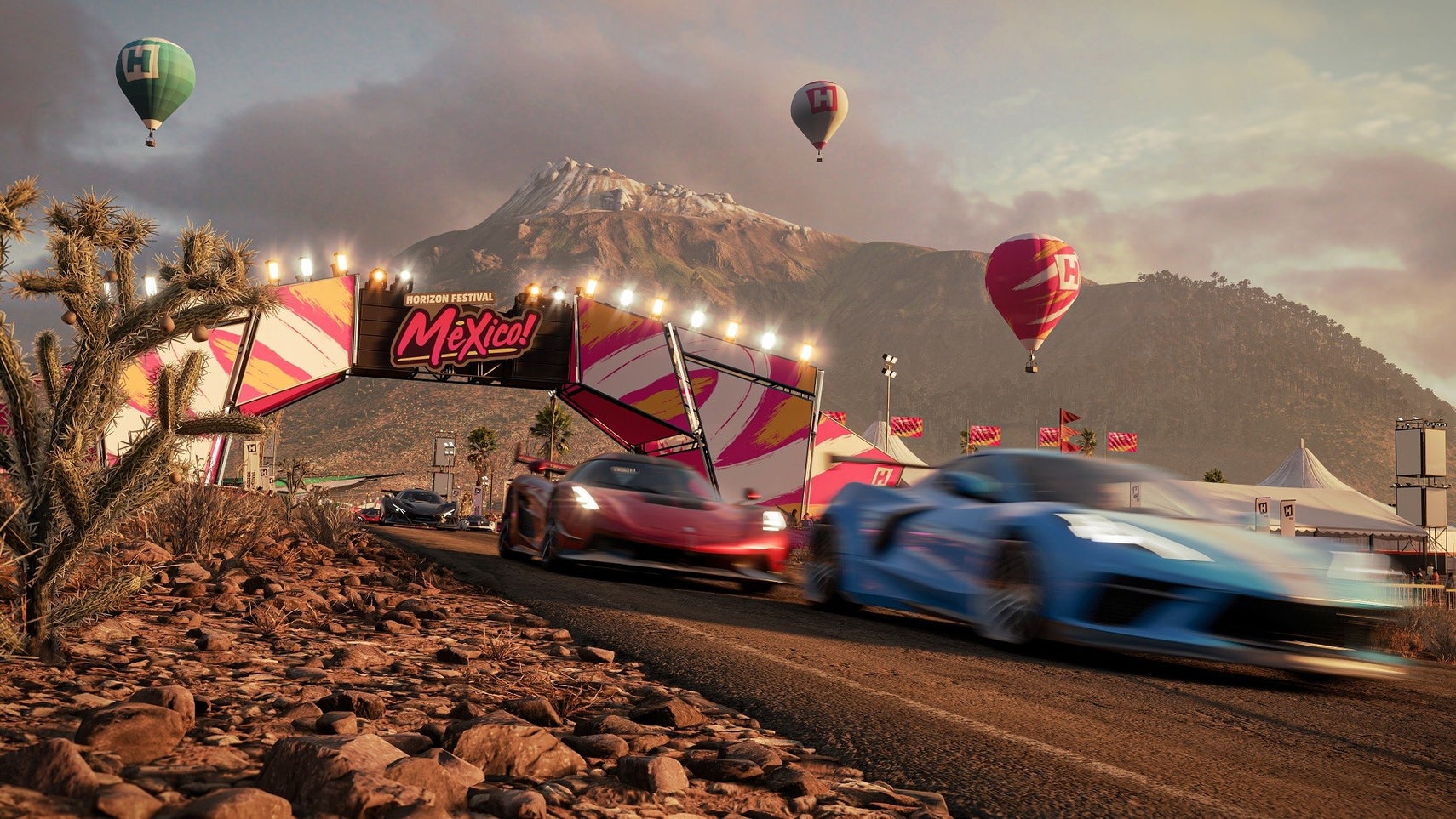 Some supercars driving under a hoarding with the logo of Mexico's Horizon festival in Forza Horizon 5. - 1