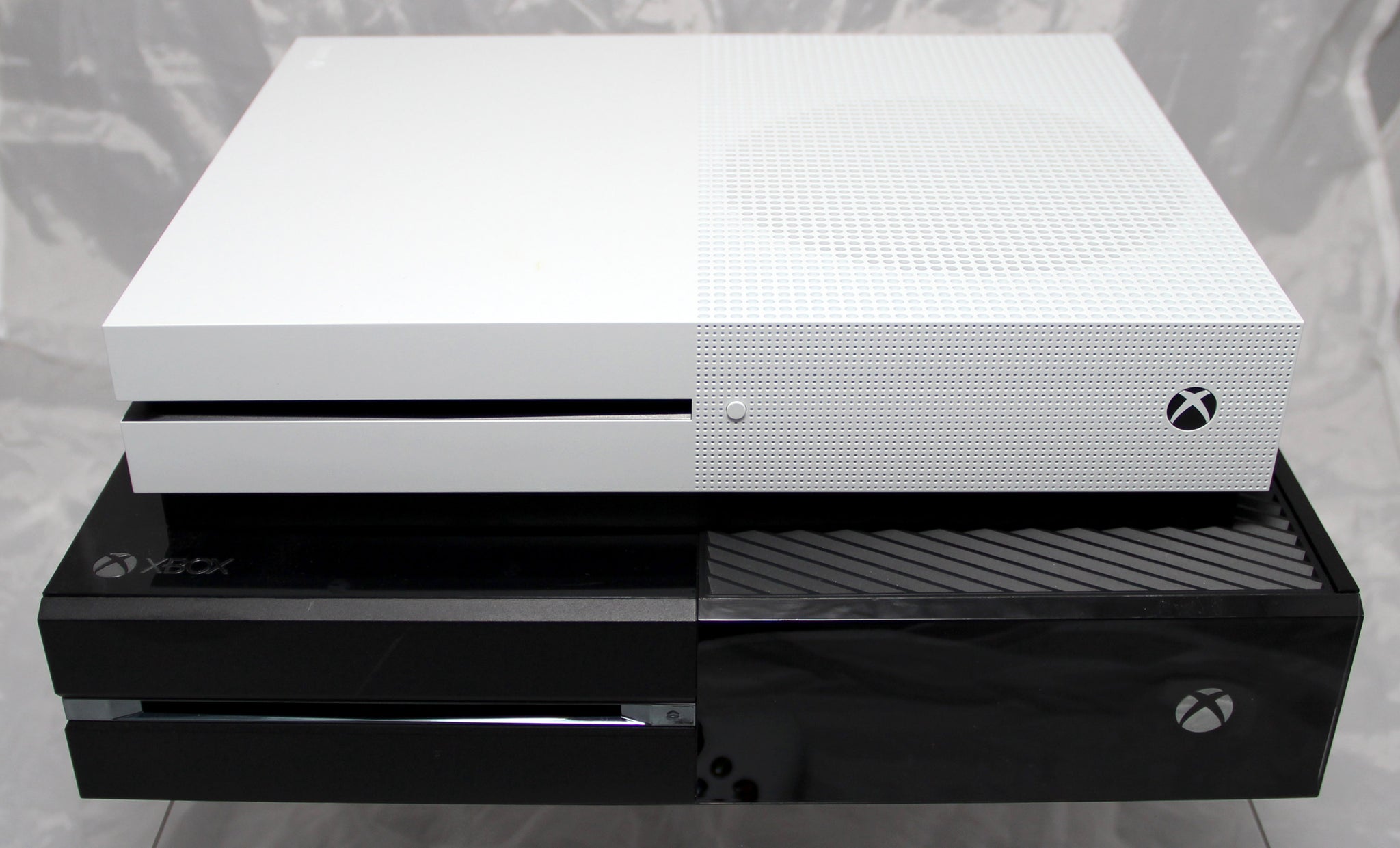 The Xbox One S stacked above the bigger, blacker, bulkier Xbox One console. - 3
