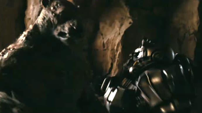 A person in power armour fighting off a yao guai in Amazon's Fallout TV series