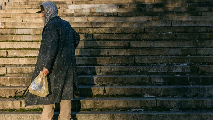 A man holds a very expensive Disco Elysium brand carrier bag.