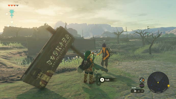 Link and Addison standing next to a fallen sign in Zelda: Tears of the Kingdom