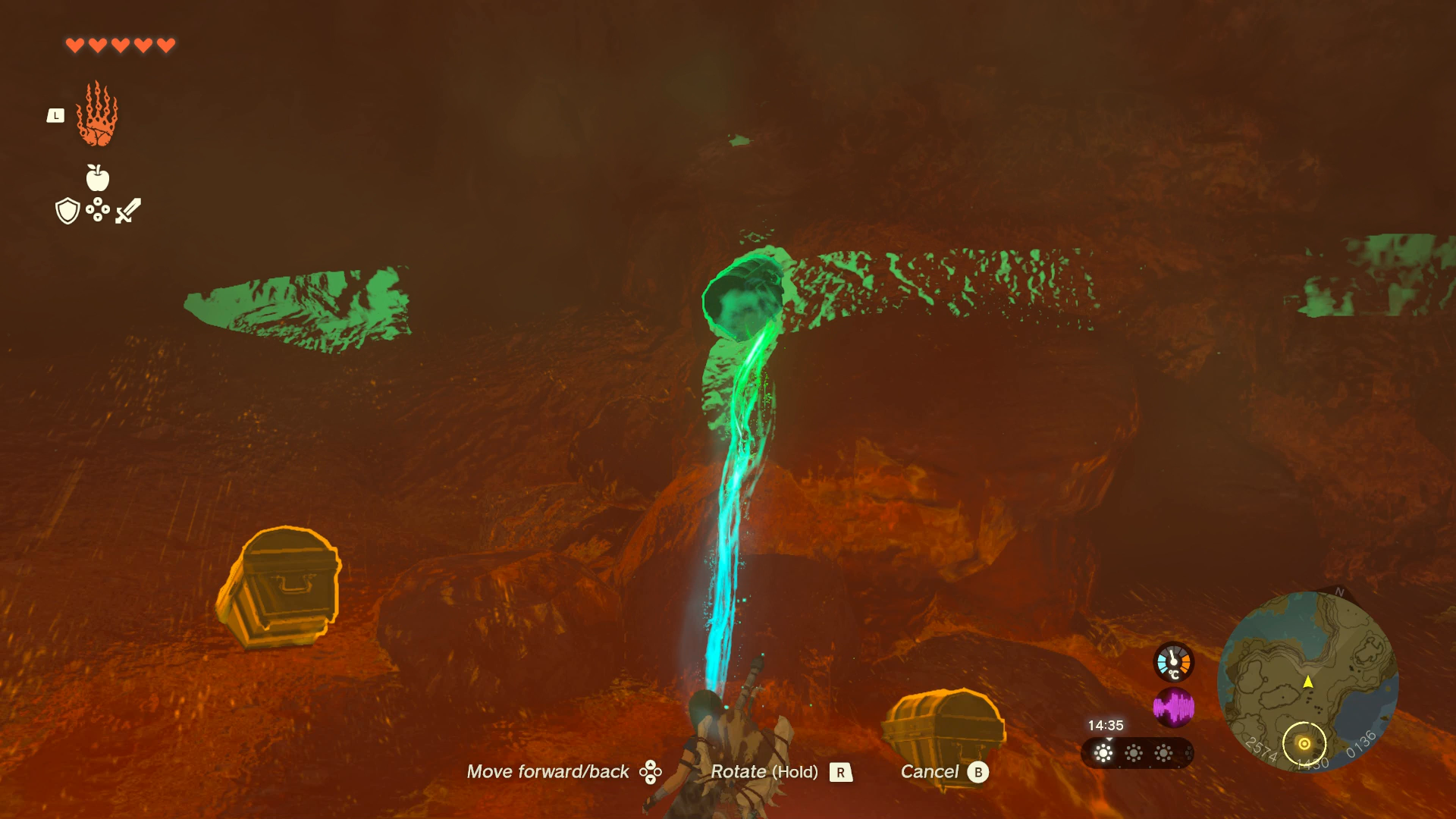 Link using Ultrahand to dislodge a chest from a cave wall